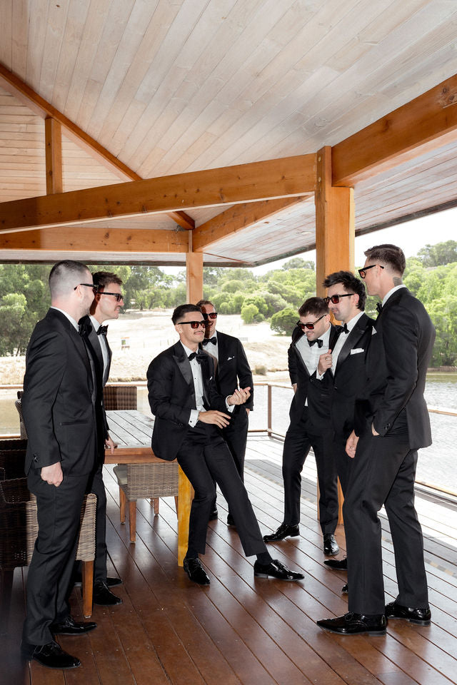 Em and Joel’s wedding party together on the deck wearing RIXX sunglasses